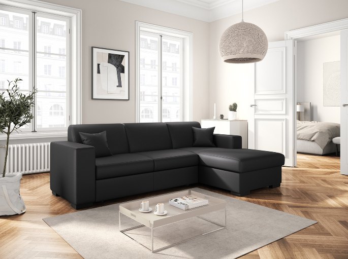 Banquette convertible grise dépliée en couchage dans un salon lumineux