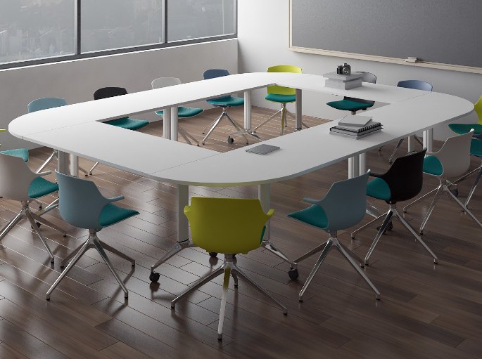 Grande table en anneau entourée de sièges colorés dans une salle de séminaire