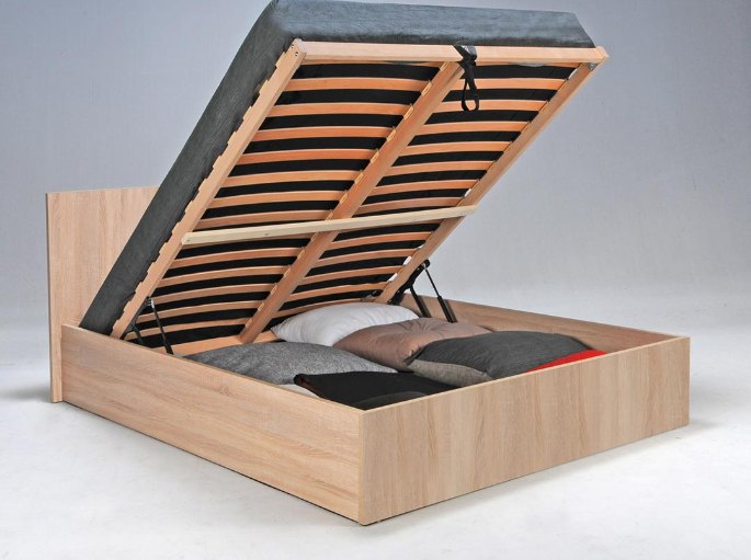 Volume intérieur accessible sous le plateau de couchage, garni de textile plié