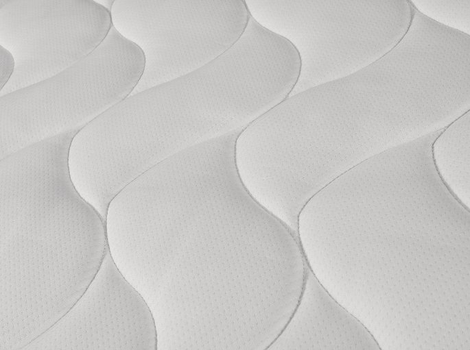 Gros plan sur le piquage du tissu de garnissage et son relief régulier