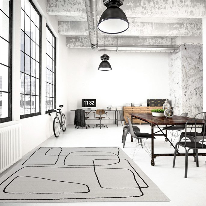 Vaste séjour de style atelier où la surface au sol prolonge la zone de travail