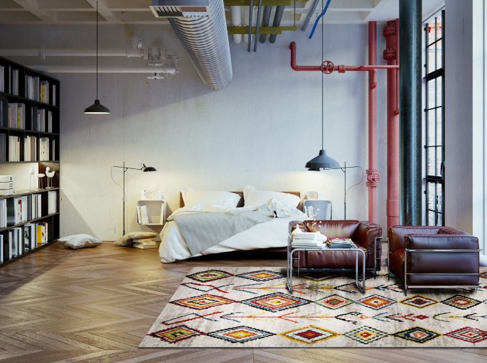 Lit double dans un loft, posé sur un grand revêtement coloré à motifs berbères