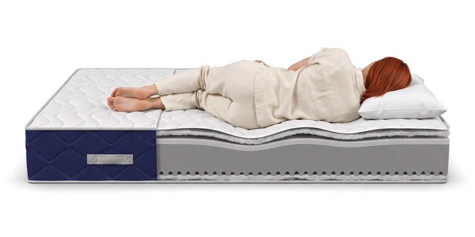 Coupe du matelas Songe sous une dormeuse allongée sur le côté