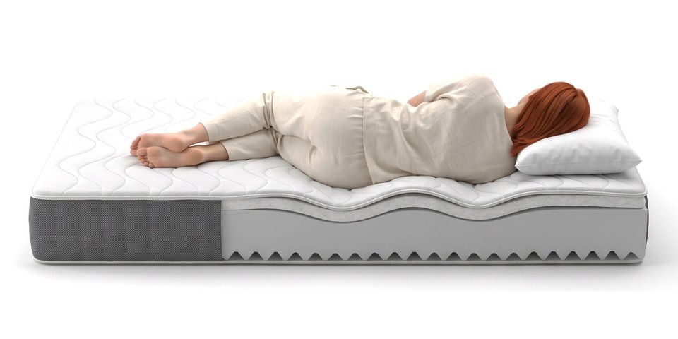 Coupe du matelas Zéphyr sous une dormeuse allongée sur le côté